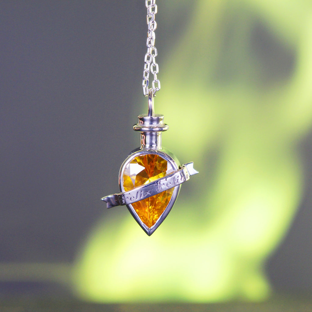Close-up of fortune elixir pendant with yellow stone