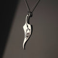Sterling silver feather necklace with engraved symbol