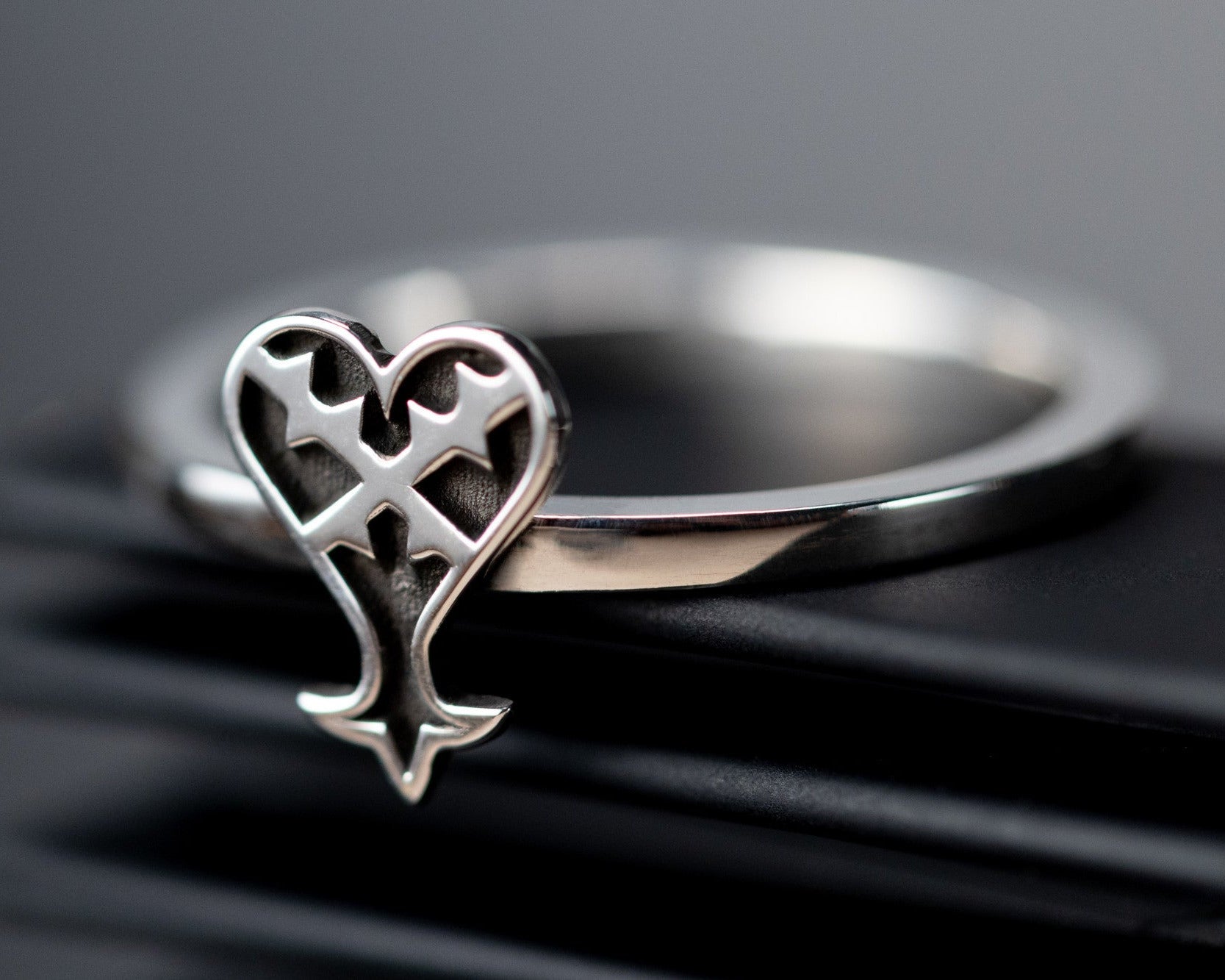 Kage ring in sterling silver with inverted heart symbol representing darkness