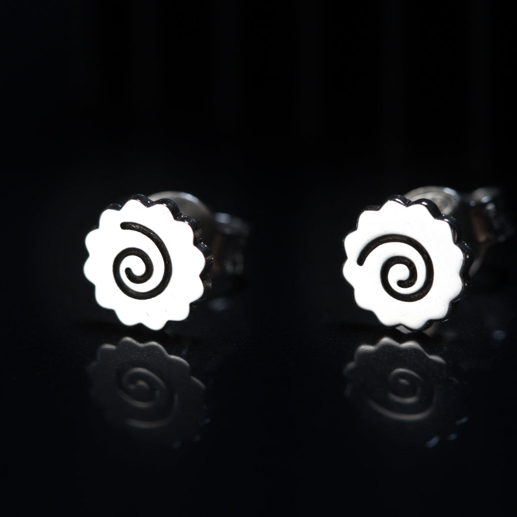 Detail of ramen earrings showing spiral narutomaki shape in sterling silver