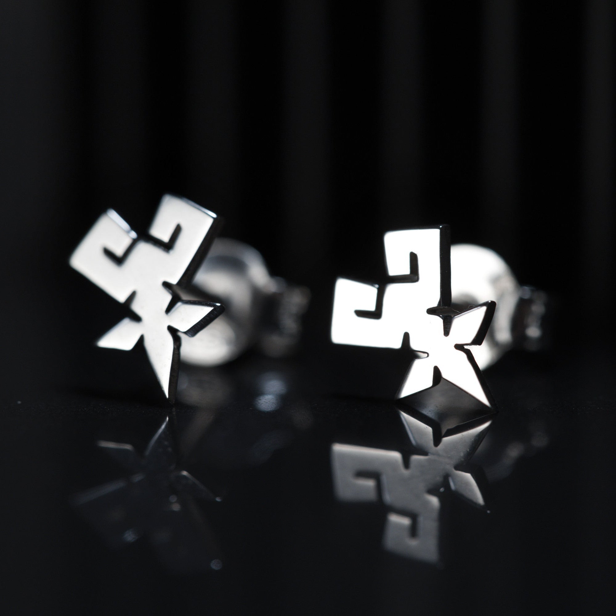 Detail of Shihan stud earrings showing clean and precise symbol in sterling silver