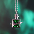 Close-up of transformation elixir pendant with green stone