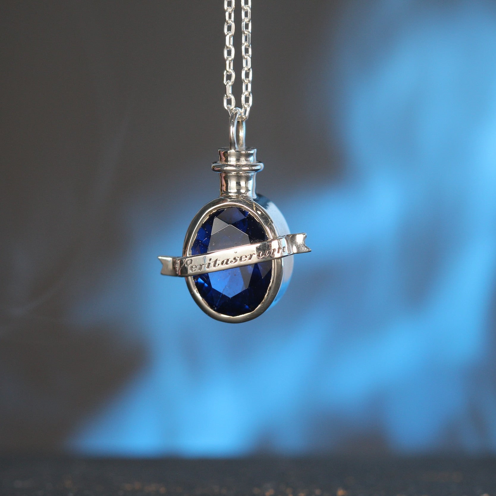 Close-up of truth elixir pendant with blue stone