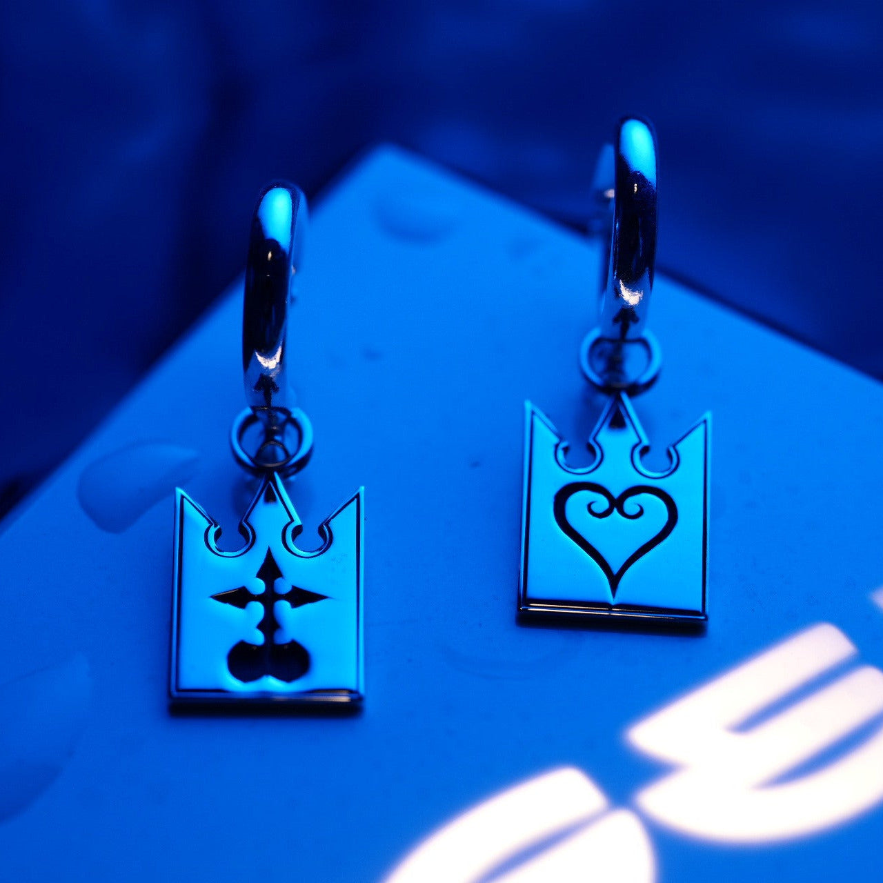 Detalle de Unmei Earrings mostrando símbolos grabados en cartas de plata de ley